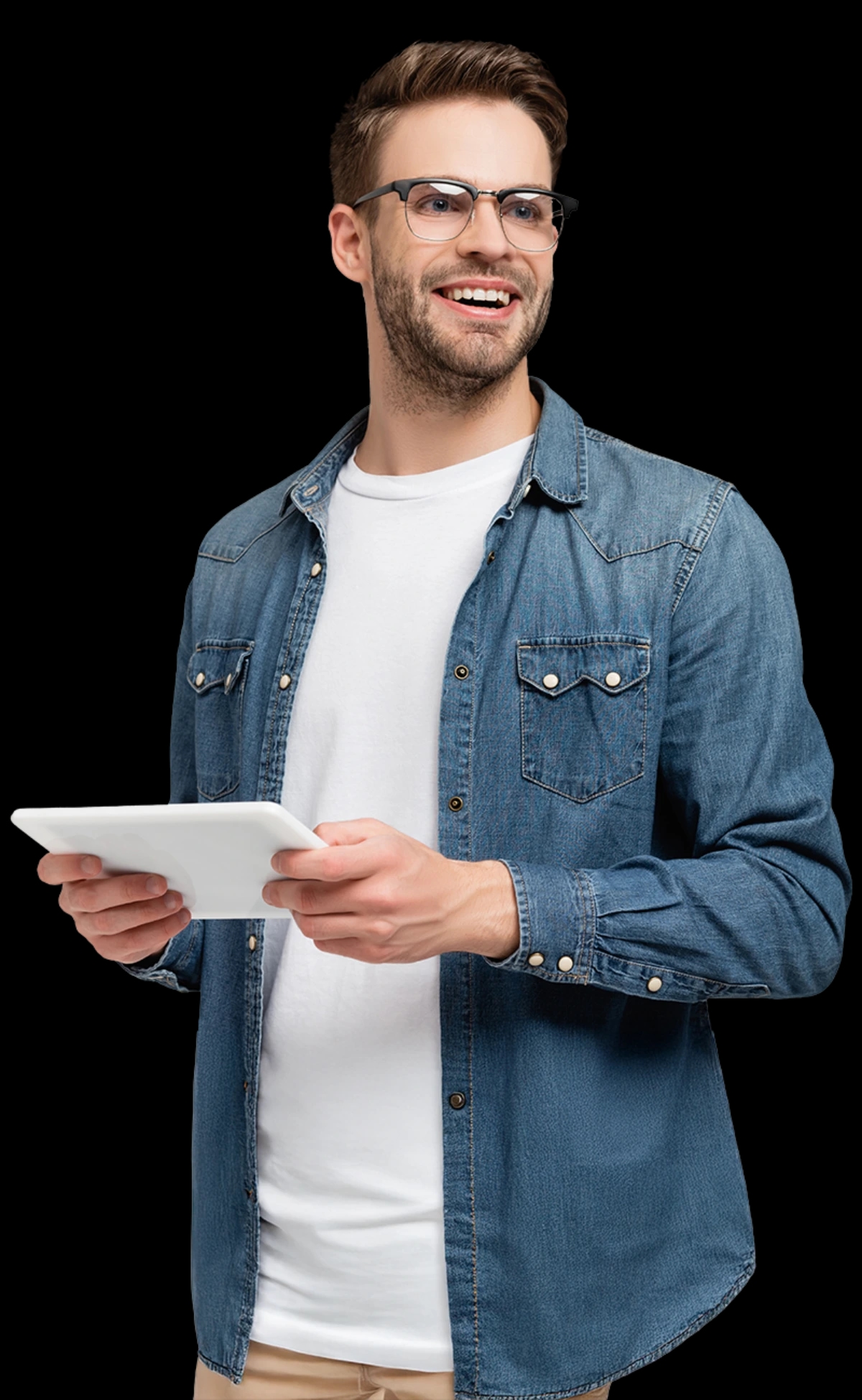 Mężczyzna w okularach trzyma laptop i uśmiecha się do kameryUśmiechnięty mężczyzna w okularach, ubrany w niebieską dżinsową koszulę i biały T-shirt, trzymający tablet w obu dłoniach i patrzący w bok na ciemnym tle.