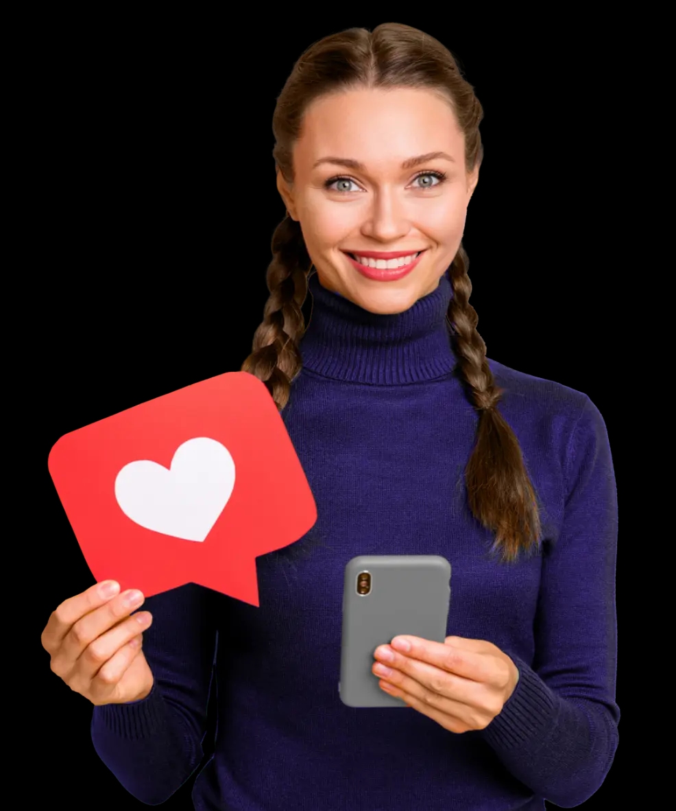 Uśmiechnięta kobieta z warkoczami trzymająca smartfon i czerwoną ikonę serca symbolizującą polubienie w mediach społecznościowych